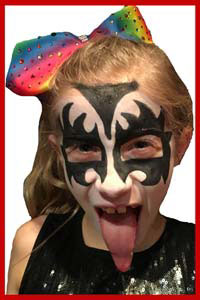 Girl poses with facepaint as rock star Gene Simmons at kids party in Westchester NY