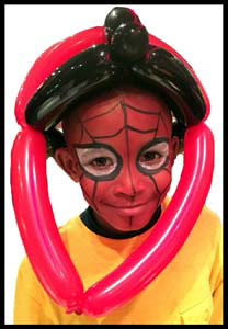 Boy wears balloon twisted helmut to match his spiderman face painting Jersey City NJ