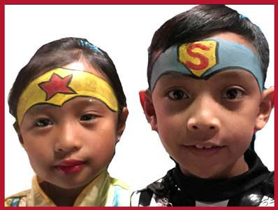 Kids are face painted as super heros at Halloween party Bronx NYC
