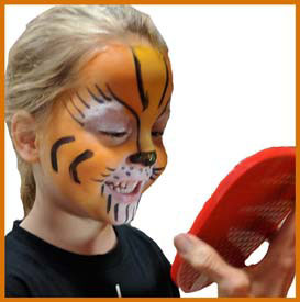 Boy admires his tiger facepainting at kids birthday party in Manhattan
