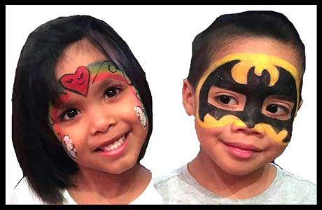 Birthday party twins smile at their facepainting by Daisy Doodle in Queens NYC