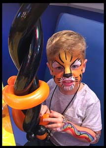 This child looks ferocious with tiger facepaint plus body painting in Brooklyn nyc