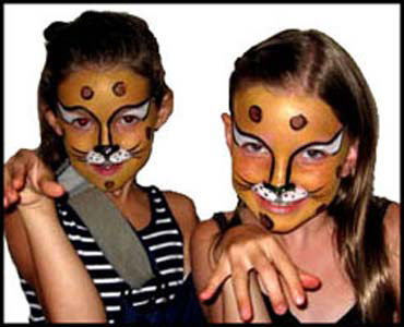 Girls pose in character with cheetah face painting at birthday party in Manhattan NYC