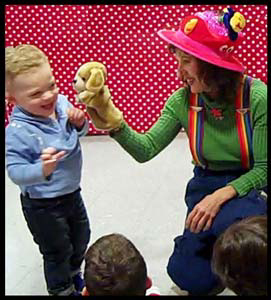 Childrens performer Daisy Doodle entertains a toddler at his 3 year birthday party in Manhattan NYC
