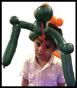 Balloon animal twister  Daisy Doodle made dinosaur hat for birthday boy in Queens NYC