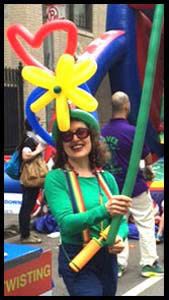 Balloon artist Daisy Doodle twisting balloons for kids at street fair in Manhattan nyc