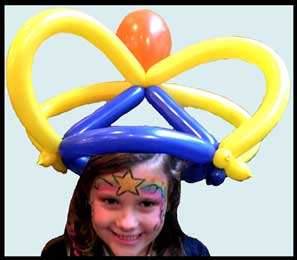 Balloon twister Daisy Doodle made balloon crown plus rainbow face painting for party in Queens NYC