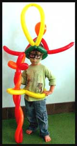 Multiple balloon twisting for birthday boy who is  facepainted as ninja turtle 