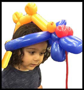 Daisy Doodle twisted balloons into a party hat for birthday boy in Manhattan NYC