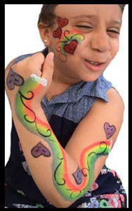 Girl gets face and body painted with rainbows and hearts at street fair Bronx NYC