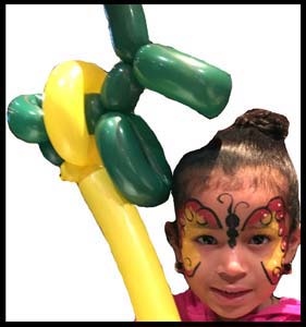 Birthday girl painted with butterfly face and holds balloon animal puppy Long Island NY