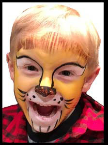 Boy roars in delight at his lion facepainting at restaurant Kids Night entertainment nyc!