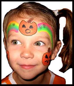Child gets facepainted with rainbow pumpkin crown at halloween party in New York City