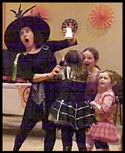 Daisy Doodle interacts with kids participating in her halloween party magic show