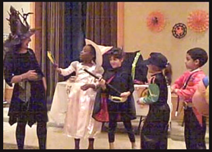 Children help out entertainer Daisy Doodle during the halloween party magic show
