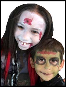 Brother and sister get facepainted to match their costumes at halloween birthday party in Brooklyn NY