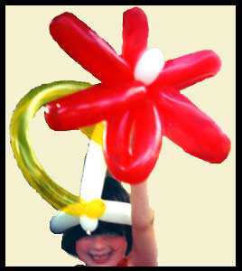GGirl smiles in delight wearing balloon twisted hat for childrens entertainment in Bronx NYC