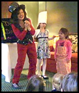 Magician Daisy Doodle with 2 children volunteers at magic show in Brooklyn NYC