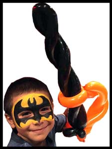 Daisy Doodle facepaints boy as batman superhero with balloon sword for superhero entertainment for kids nyc