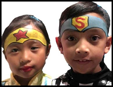 Kids are facepainted as Wonder Woman and Superman at superhero birthday party nyc