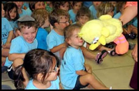 Toddlers enjoy interacting with puppet for summer camp party entertainment in Bronx NYC